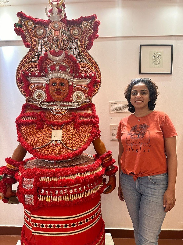 With the Theyyam statue